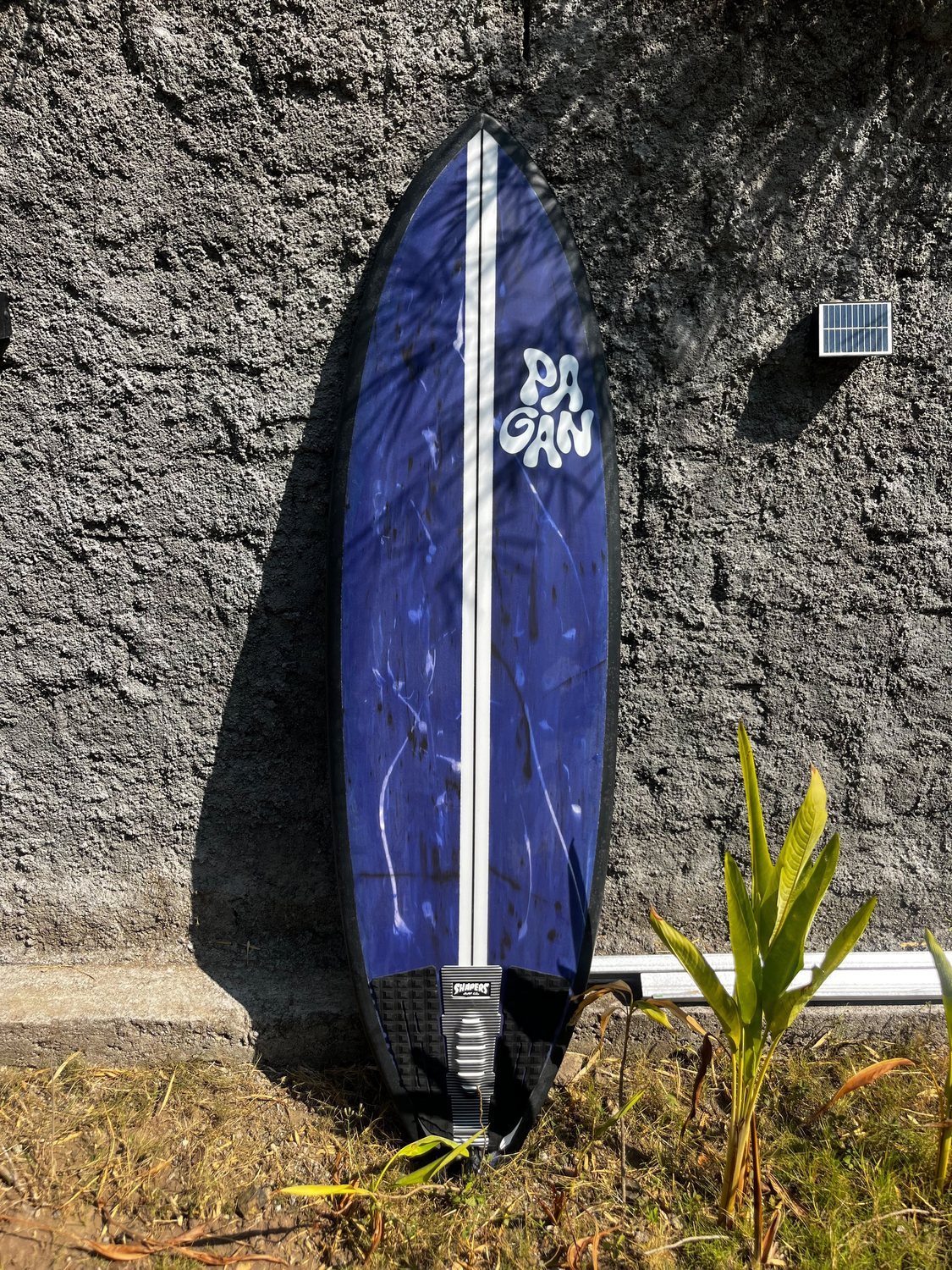 Navy board against a lava-stone wall